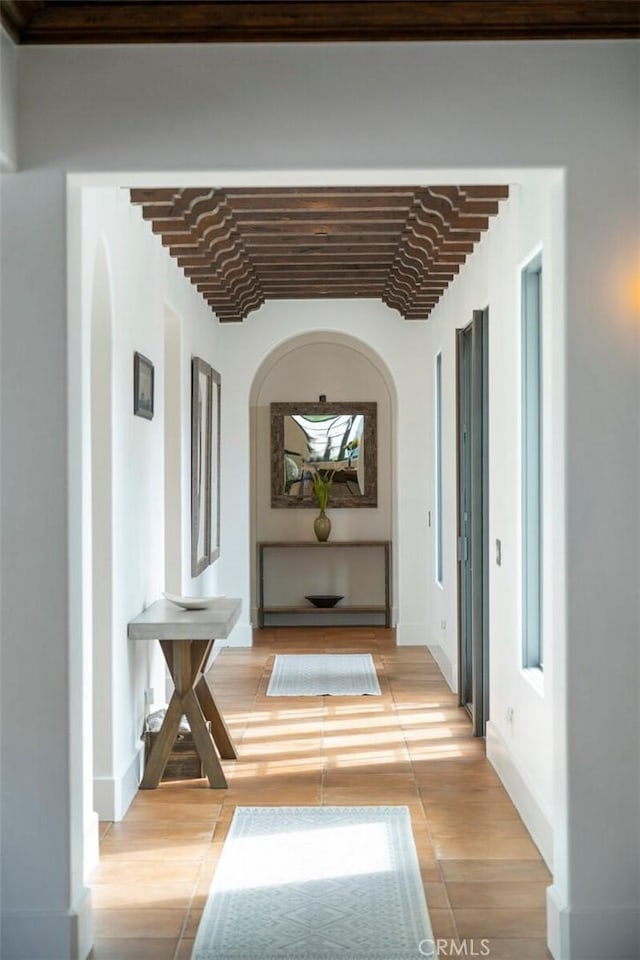 hall featuring brick ceiling and light wood-type flooring