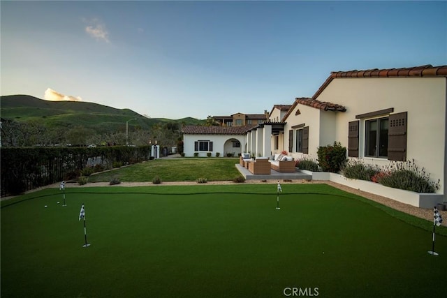 surrounding community with a mountain view, an outdoor hangout area, and a patio area