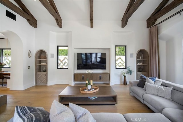 living room with a healthy amount of sunlight and built in shelves