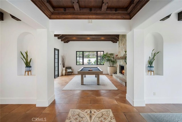 playroom featuring billiards, a stone fireplace, wood ceiling, beamed ceiling, and tile patterned flooring