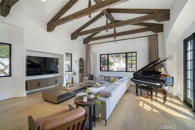 living room featuring high vaulted ceiling, beamed ceiling, and light wood-type flooring