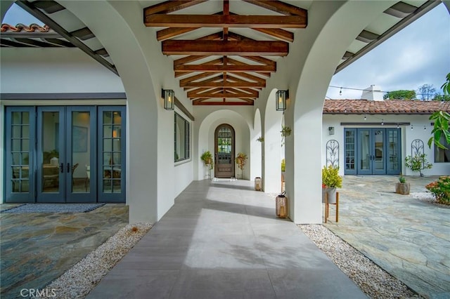 property entrance featuring french doors and a patio area