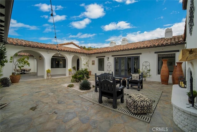 rear view of house with french doors and a patio area