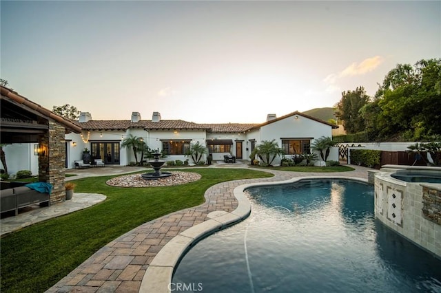 view of swimming pool with an in ground hot tub and a patio area