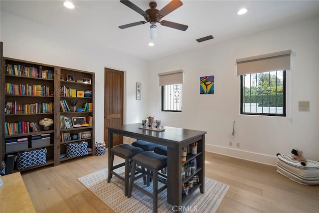 dining area with ceiling fan and light wood-type flooring