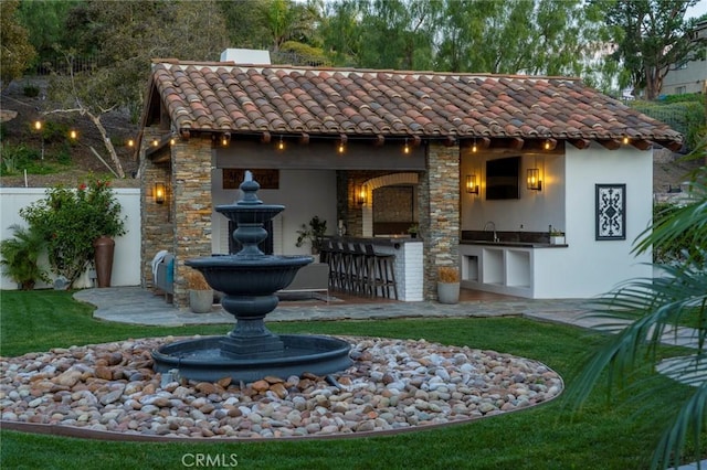 rear view of property featuring a wet bar