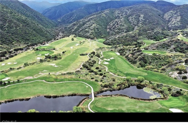 birds eye view of property with a water and mountain view