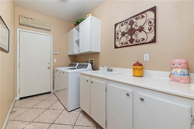 clothes washing area featuring sink, light tile patterned floors, cabinets, and washing machine and clothes dryer