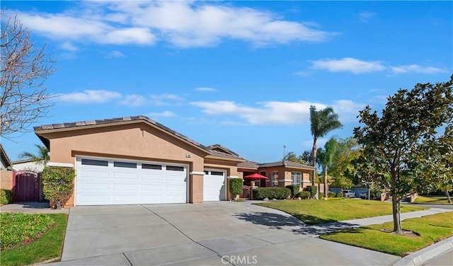 single story home with a garage and a front lawn