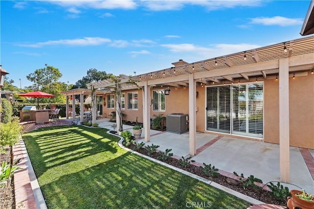 rear view of property featuring a patio, a yard, cooling unit, and a pergola