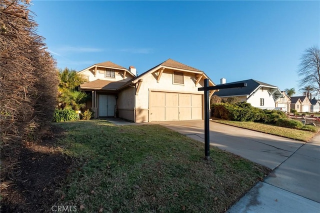 view of front property featuring a garage and a front lawn