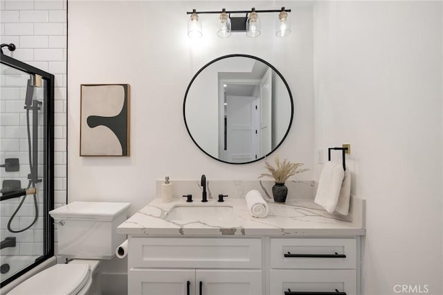 full bathroom featuring toilet, vanity, and shower / bath combination with glass door