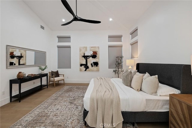 bedroom featuring ceiling fan, high vaulted ceiling, and hardwood / wood-style floors