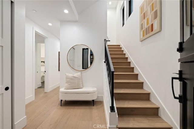 staircase with wood-type flooring