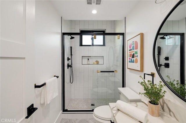 bathroom with toilet and walk in shower