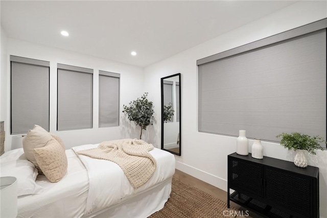 bedroom with hardwood / wood-style flooring