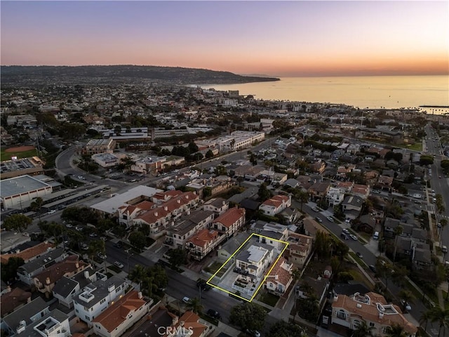 aerial view at dusk with a water view