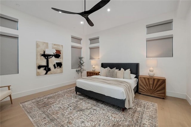 bedroom with light hardwood / wood-style flooring and ceiling fan