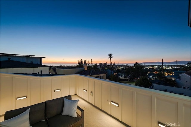 patio terrace at dusk with a balcony