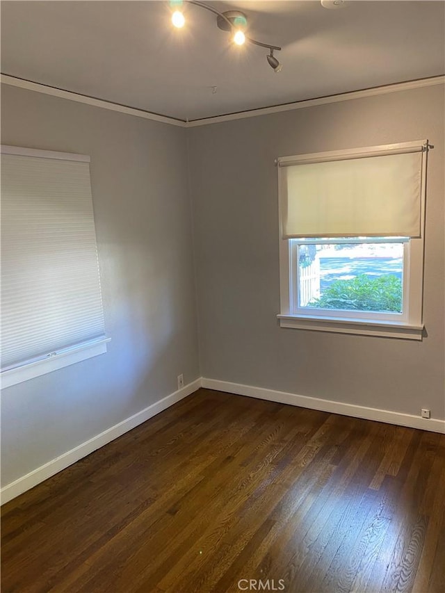 empty room with dark wood finished floors and baseboards