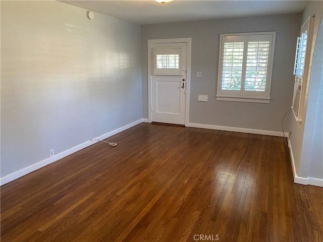 entryway featuring baseboards and dark wood-style flooring