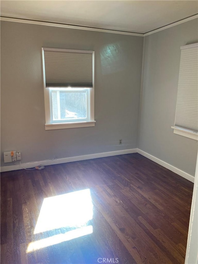 unfurnished room with wood finished floors and baseboards