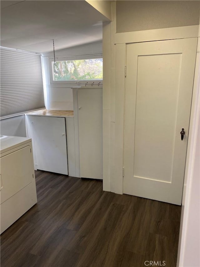 clothes washing area with dark wood-style floors, laundry area, and washer / dryer