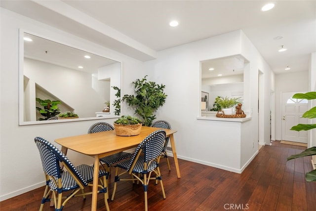 dining area with dark hardwood / wood-style flooring