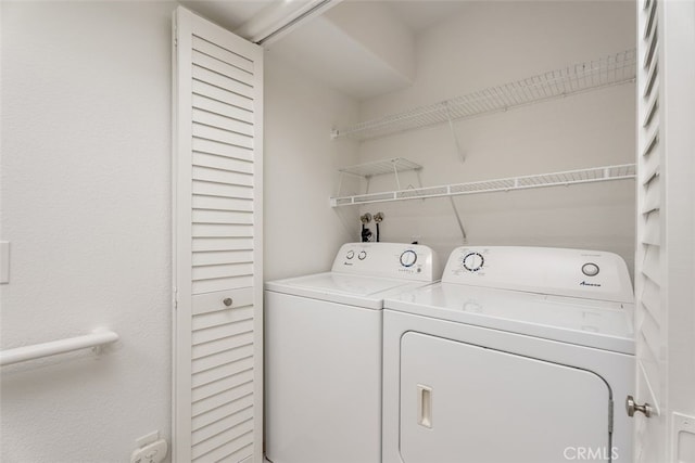 clothes washing area featuring washer and dryer