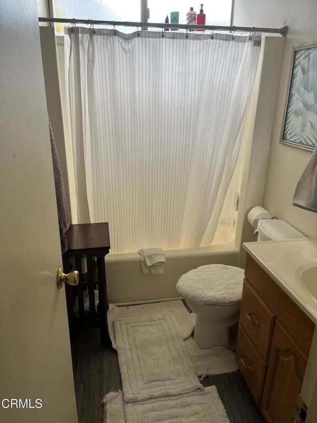 full bathroom with vanity, shower / bathtub combination with curtain, and toilet