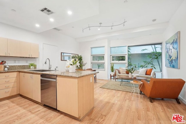 kitchen featuring dishwasher, sink, kitchen peninsula, light brown cabinets, and light hardwood / wood-style flooring