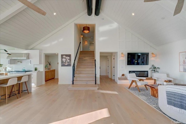 living room featuring beam ceiling, high vaulted ceiling, wood ceiling, and light hardwood / wood-style floors