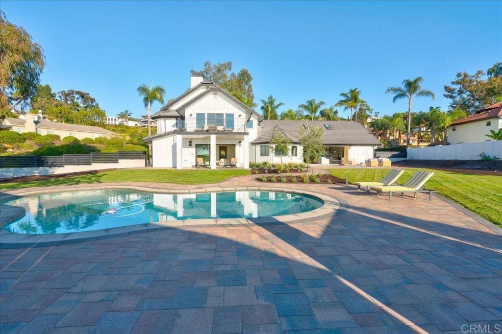 view of pool featuring a patio area and a lawn