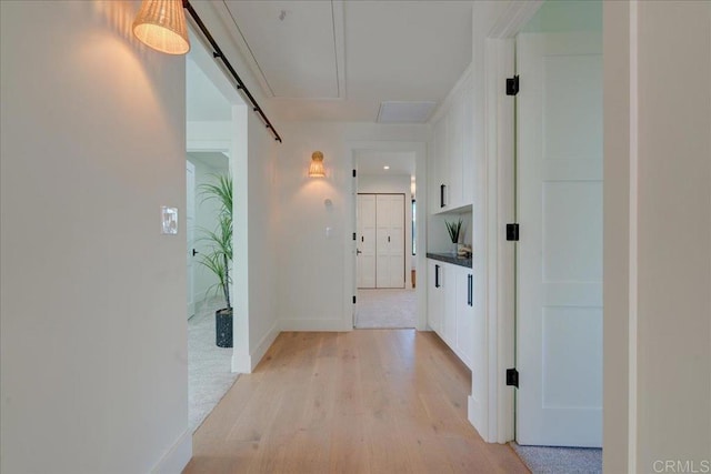 corridor featuring a barn door and light wood-type flooring