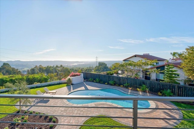 view of swimming pool with a mountain view and a patio