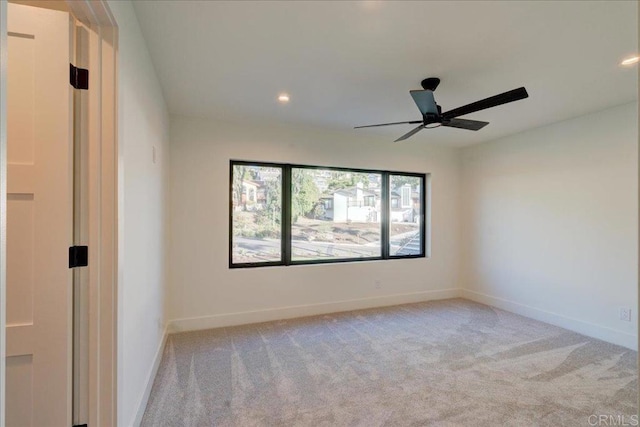 carpeted empty room featuring ceiling fan