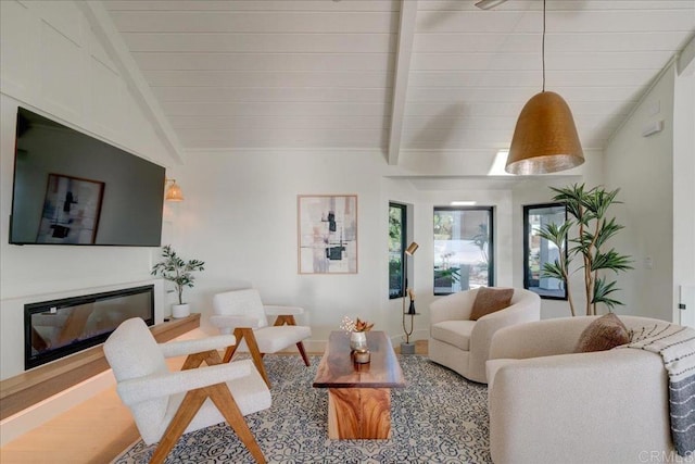 living room with vaulted ceiling with beams