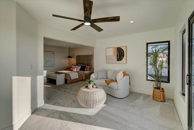 carpeted living room with ceiling fan