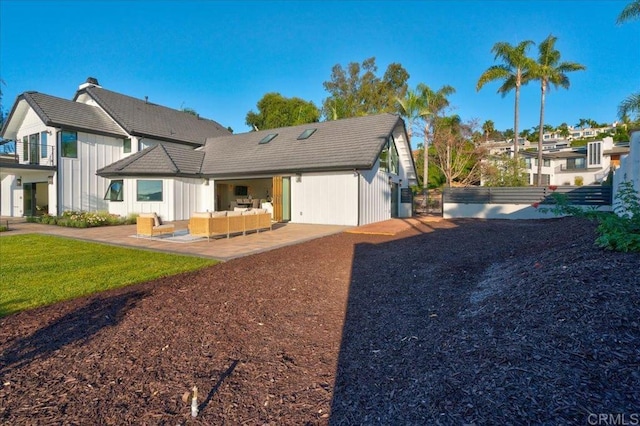 back of property with an outdoor hangout area and a patio area