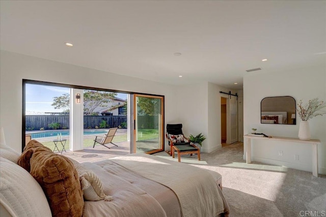 bedroom with a barn door, access to outside, and light colored carpet