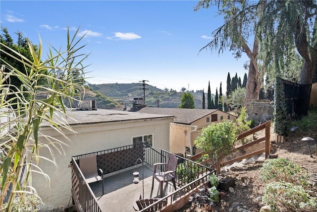 view of side of home with a mountain view and a patio area