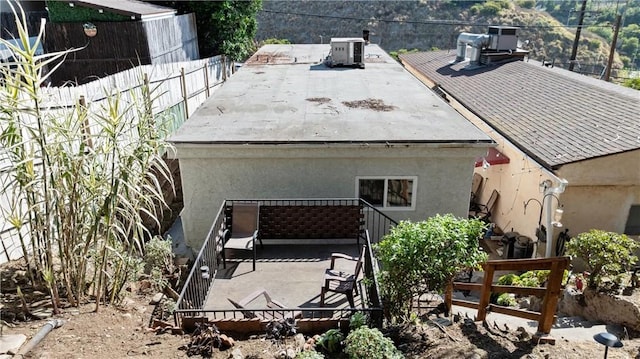 rear view of house with central AC unit