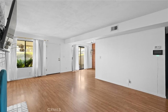 unfurnished room with light wood-type flooring