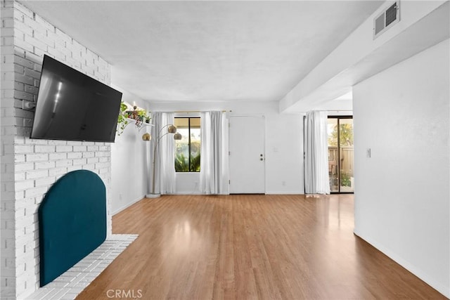 foyer with wood-type flooring and a fireplace