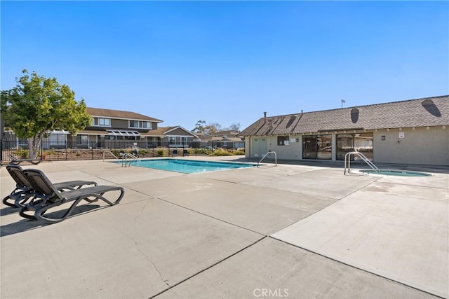 view of swimming pool with a community hot tub and a patio area