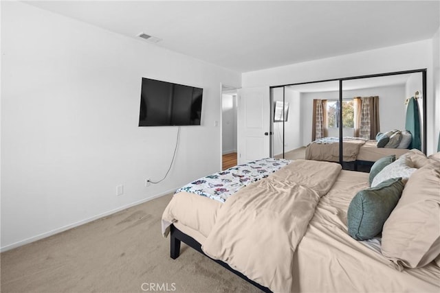 bedroom with light carpet and a closet