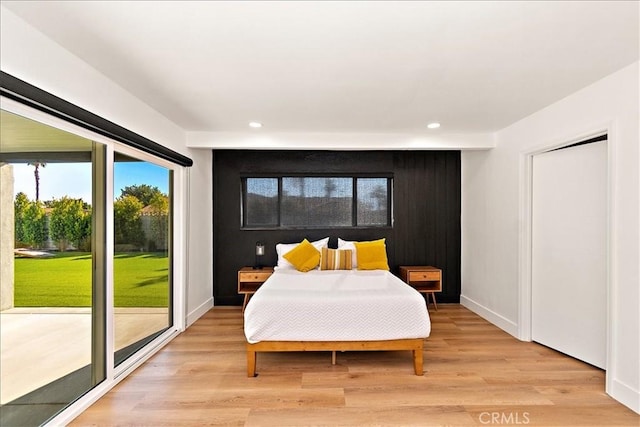 bedroom featuring access to exterior and light hardwood / wood-style floors