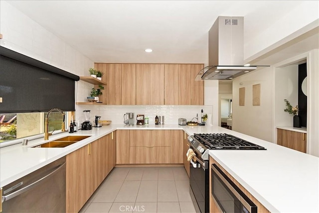 kitchen with light tile patterned flooring, appliances with stainless steel finishes, island range hood, light brown cabinetry, and sink