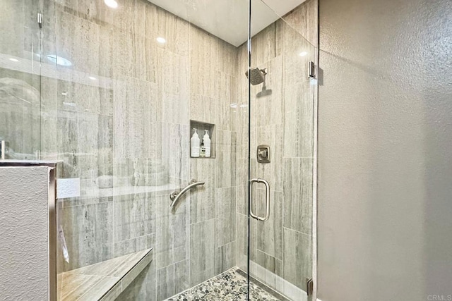 bathroom with a shower with door