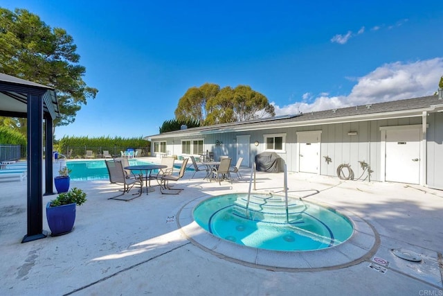 view of pool with a community hot tub and a patio area